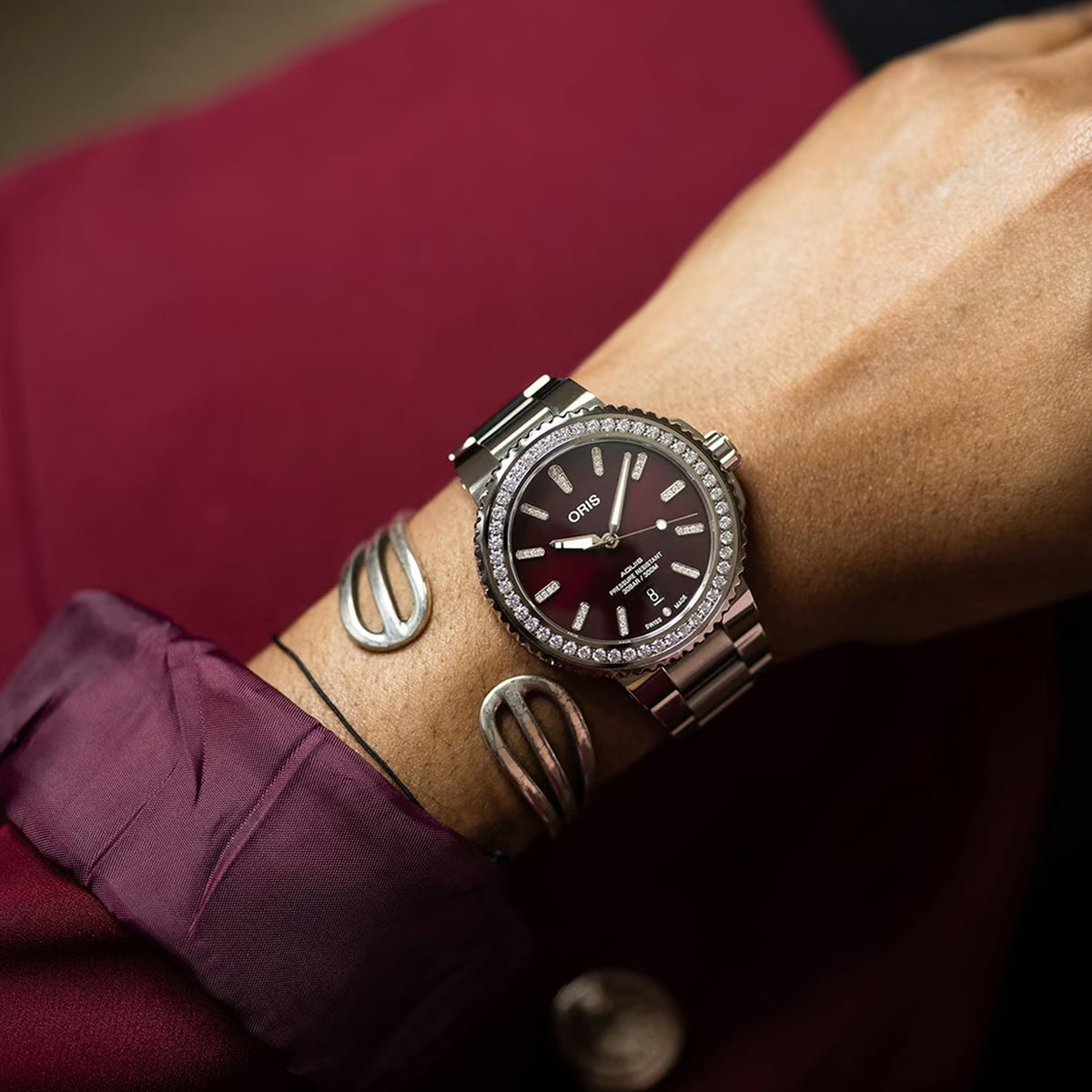 The Oris Aquis Date Relief 41.50cmm Automatic Watch 733 7766 4998MB worn on the wrist to show scale and fit. The 41.5mm diamond-set case and stainless steel bracelet suit both formal and everyday wear.
