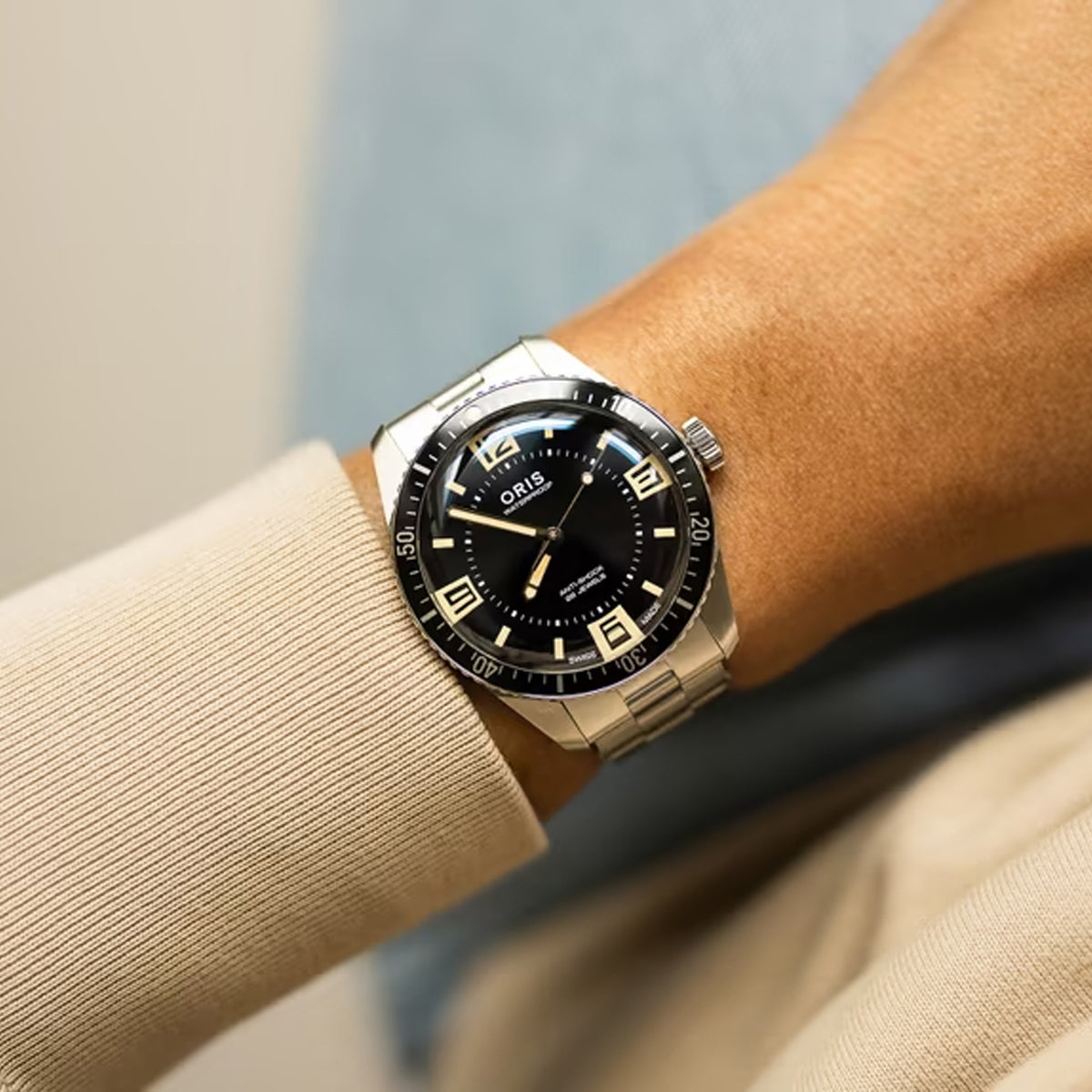 The Oris Sixty Five Automatic Men's 40mm Watch 733 7772 4034SET worn on the wrist to show scale and fit. The 40mm stainless steel case and bracelet suit both casual and smart-casual wear.