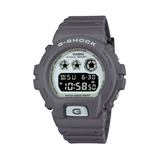 Casio G-SHOCK DW6900HD-8D digital watch with grey resin band, black LCD display, triple graph face, and shock-resistant design.