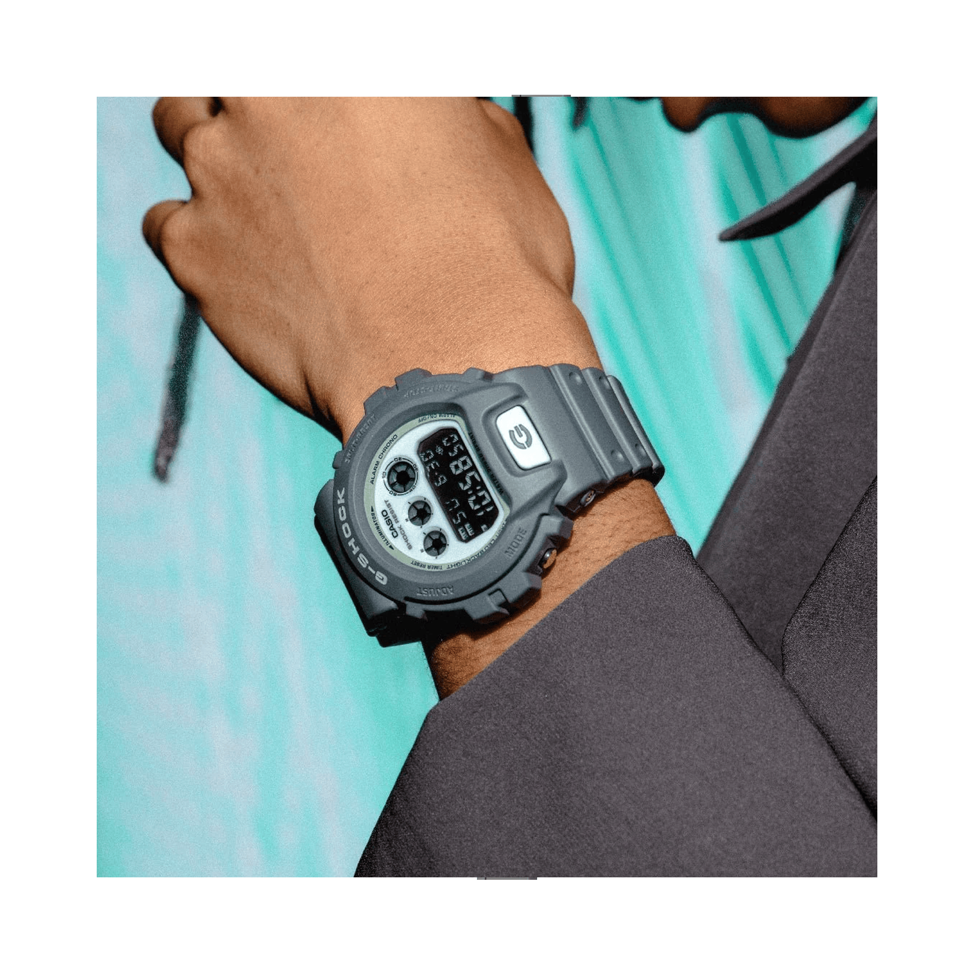 Casio G-SHOCK DW6900HD-8D digital watch with grey resin band, black LCD display, triple graph face, and shock-resistant design - on wrist