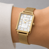 The Loyal Academy Gold PVD Women's Watch worn on the wrist, showing the true scale of the 24.50mm case and Mother of Pearl dial. The Gold PVD finish and mesh bracelet give this quartz watch a polished, versatile look for daily wear.