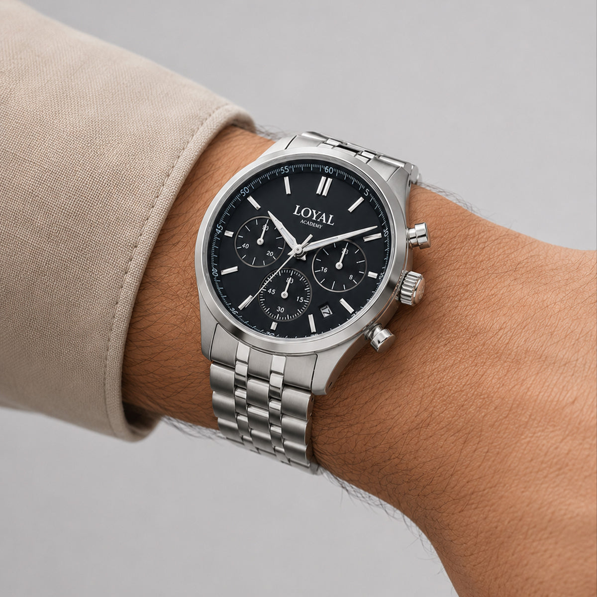 The Loyal Academy Steel Chronograph Watch worn on the wrist, showing the true scale of the 40mm case and black chronograph dial. The stainless steel finish and matching bracelet give this quartz watch a sporty, versatile look for daily wear.