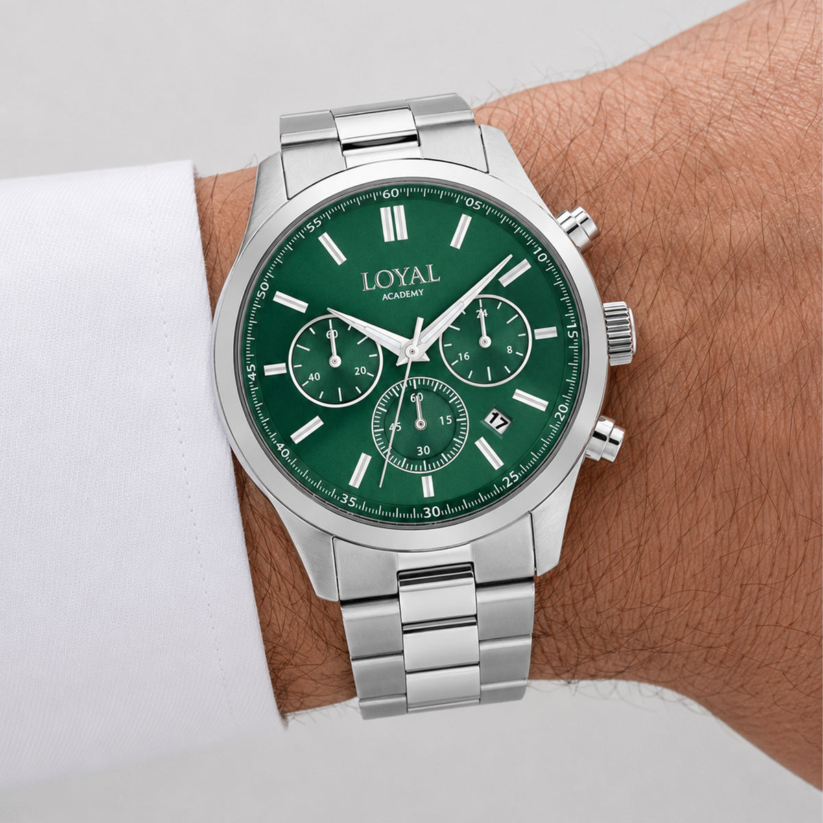 The Loyal Academy Steel Chronograph Watch worn on the wrist, showing the true scale of the 40mm case and green chronograph dial. The stainless steel finish and matching bracelet give this quartz watch a sporty, versatile look for daily wear.