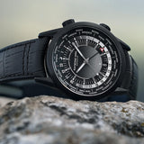 Close-up of the gradient black dial on the Raymond Weil Freelancer GMT Worldtimer Men's 40.5mm Automatic Watch 2765-BKC-20001. The detail shows the world time city ring, GMT hand and date display beneath scratch-resistant sapphire crystal.