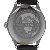 Close-up of the back of a Timex watch with a stainless steel case and black leather strap, showing engraved text and a globe design on the case.