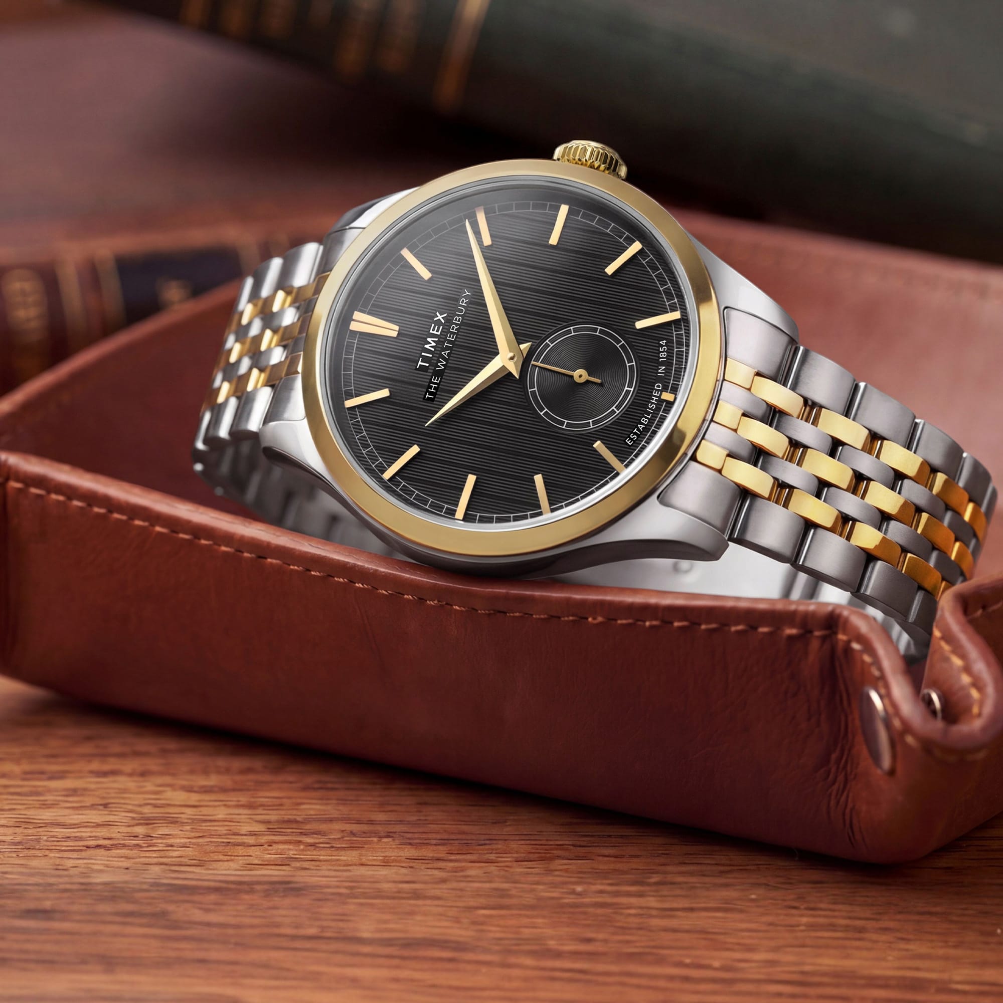 The Timex Waterbury Traditional Quartz 39mm Watch TW2Y91900 suits both the office and smart-casual dressing, worn day-to-day. The textured black dial and two-tone bracelet bring a timeless yet fresh look to any outfit.