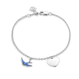 Front-on view of the Wallace Bishop Bluebird of Happiness Heart Bracelet in Sterling Silver for children, reference 32BLBB01, measuring 160mm in length. A small blue enamel bluebird and a polished silver heart are shown as solid charms.