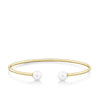 Front-on view of the Wallace Bishop Freshwater Pearl Flexi Bangle in 9ct Yellow Gold, reference 33BGPBY, measuring 50 x 60mm. A 7mm round white freshwater pearl sits at each end of the open cuff-style bangle.