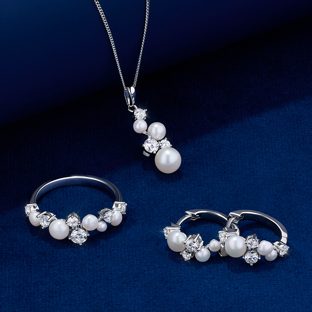 The Wallace Bishop Freshwater Pearl & Cubic Zirconia Pendant in Sterling Silver, reference 33PDCZ36, measuring 18.8mm in length, shown together with the Freshwater Pearl & Cubic Zirconia Ring in Sterling Silver, reference 33RGCZ36O, and the hoop earrings, reference 33ESCZ36. The pendant and ring each feature a cluster of round freshwater pearls and round cubic zirconias in polished sterling silver.