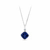 A 9ct white gold pendant shown front on, featuring a cushion cut created sapphire in dark royal blue, complemented by a small round brilliant cut natural diamond. Measuring 18mm x 10.5mm.