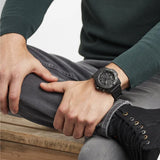 Luminox Navy SEAL Men's 45mm Black Quartz Chronograph Watch XS.3581.BO worn on the wrist to show its size and fit. This Navy SEAL Chronograph Blackout watch features a black dial with three sub-dials, a black dive bezel and a lightweight black CARBONOX™ case on a black strap.