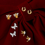 Front-on view of four pairs of Wallace Bishop stud earrings: the 0.06 TDW Round Diamond Butterfly Stud Earrings in 9ct White Gold, reference 3EBFL01W, the 0.03 TDW Round Citrine & Diamond Bee Stud Earrings in 9ct Yellow Gold, reference 93CBEE9Y, the 0.02 TDW Round Diamond Hummingbird Stud Earrings in 9ct Yellow Gold, reference 3ED02Y, and the Horseshoe Stud Earrings in 9ct Yellow Gold, reference 39ER130, with each pair shown as two earrings.