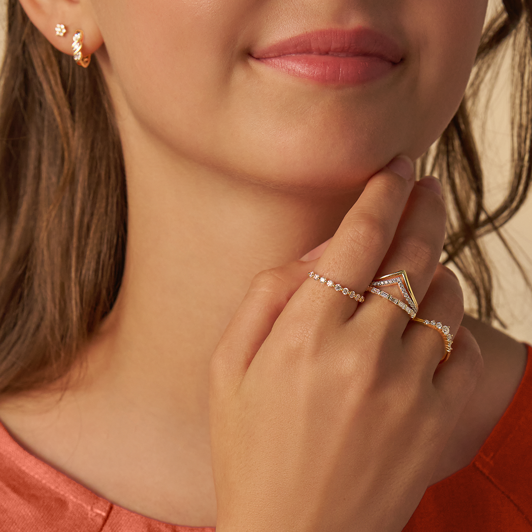 Model posing with various diamond rings in Yellow and White Gold