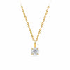 A classic solitaire necklace featuring a round brilliant-cut diamond pendant in a yellow gold four-prong setting, suspended from a matching yellow gold cable chain against a solid white background.