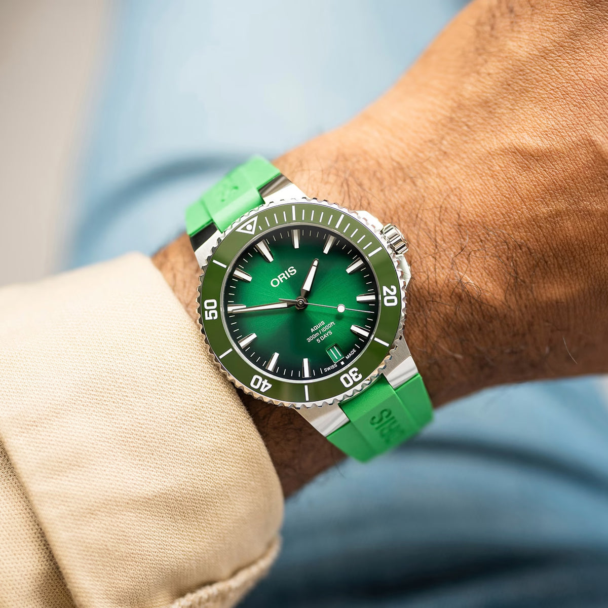 Oris Aquis Date Calibre 400 43.50mm Automatic Watch 01 400 7790 4157-07 4 23 47EB worn on the wrist — The 43.50mm case sits boldly on the wrist, with the deep green dial and matching ceramic bezel visible in natural light. The green rubber strap conforms comfortably to the wrist with the security folding clasp sitting flush against the skin.