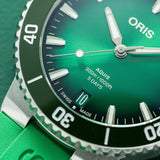 Oris Aquis Date Calibre 400 43.50mm Automatic Watch 01 400 7790 4157-07 4 23 47EB — A close-up of the green sunray dial reveals the applied luminous baton indices, slim luminous hands and date window at 6 o’clock. The domed sapphire crystal with anti-reflective coating sits above the dial, reducing glare for clear legibility in all lighting conditions.