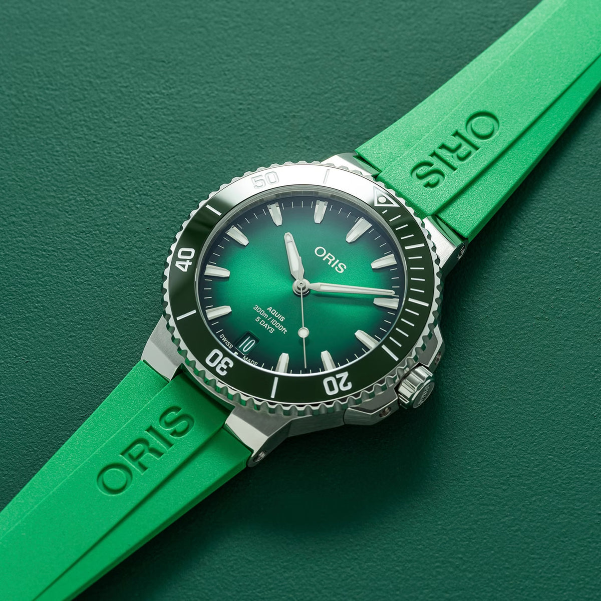 Oris Aquis Date Calibre 400 43.50mm Automatic Watch 01 400 7790 4157-07 4 23 47EB — A three-quarter angle view shows the stainless steel case profile, the green ceramic unidirectional rotating bezel with minutes scale in relief, and the screw-down crown at the 3 o’clock position. The brushed and polished case finishing is visible across the lugs and mid-case.