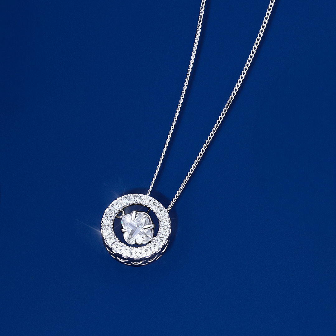 Flat lay view of the Wallace Bishop Cubic Zirconia Dancing Pendant in Sterling Silver, reference 41PCZD04, measuring 10mm, laid flat. The polished pendant features a single colourless round cubic zirconia in a claw setting.