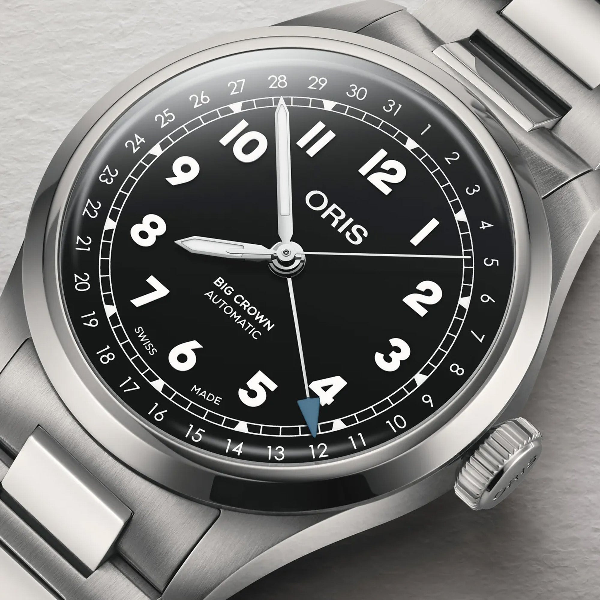 Oris Big Crown Pointer Date 40mm Automatic Watch 01 754 7798 4064-07 8 20 06 — A close-up of the black dial highlights the large luminous Arabic numerals, railway-style minute track and the blue-tipped central pointer date hand indicating the date on the outer scale. The applied indices and hands are coated in Super-LumiNova for low-light legibility.