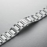 The 40mm stainless steel case sits confidently on the wrist, showing the black dial and oversized screw-down crown at the 3 o'clock position. The H-link bracelet fits closely and comfortably against the skin.