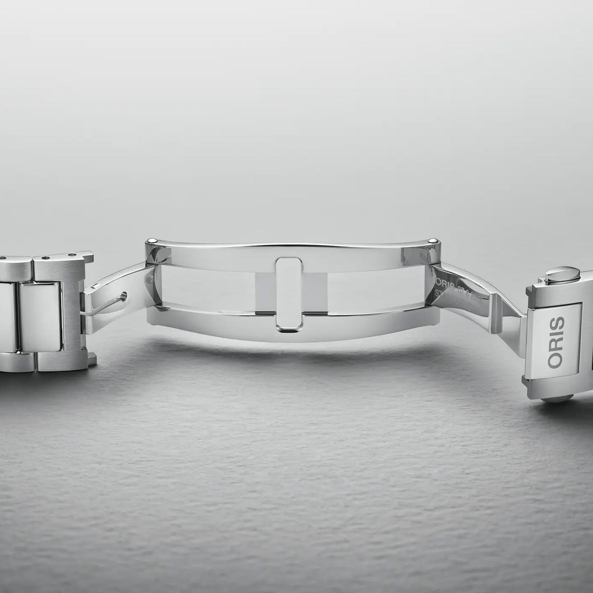 The 40mm stainless steel case sits confidently on the wrist, showing the black dial and oversized screw-down crown at the 3 o'clock position. The H-link bracelet fits closely and comfortably against the skin.