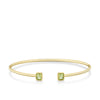 Front-on view of the Wallace Bishop Peridot Flexi Bangle in 9ct Yellow Gold, reference 93BGPBY, a cuff-style bangle measuring 50mm by 60mm. The bangle features a bezel-set 5x4mm natural emerald cut peridot on each side.
