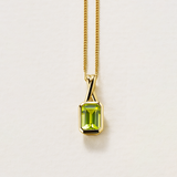 Emerald Cut Peridot Twist Bezel Set Pendant in 9ct Yellow Gold