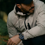 Luminox RECON Nav Spec Men's 46mm Quartz GMT Watch XL.8833 worn on the wrist to show its size and fit. This RECON Nav Spec watch features a black dial with blue accents, a two-tone rotating bezel and a lightweight CARBONOX™ case on a black rubber strap.