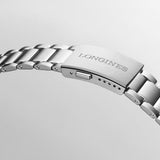 Close-up of a Longines silver watch band with 'Longines' engraving on the clasp