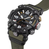 Casio G-Shock Mudmaster GGB100X-1A3 watch front view, featuring a large 55.4mm carbon fibre reinforced resin case with triple-layered carbon bezel, analogue hands, inverted LCD digital display, and khaki band accents on a black base - close up