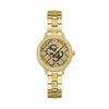 The Guess GW0944L2 is shown face-on, highlighting its 34mm gold-tone case and full crystal bezel. The black Quattro 'G' logo adds a delicate pop of contrast to the champagne dial.