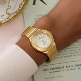 Gold-tone Timex Q Mini women’s watch featuring a 30mm stainless steel case, cream analog dial, luminous hour markers, and a matching expansion bracelet with vintage-inspired styling - on wrist