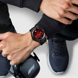 Person wearing a Black Tag Hauer smartwatch with red accents