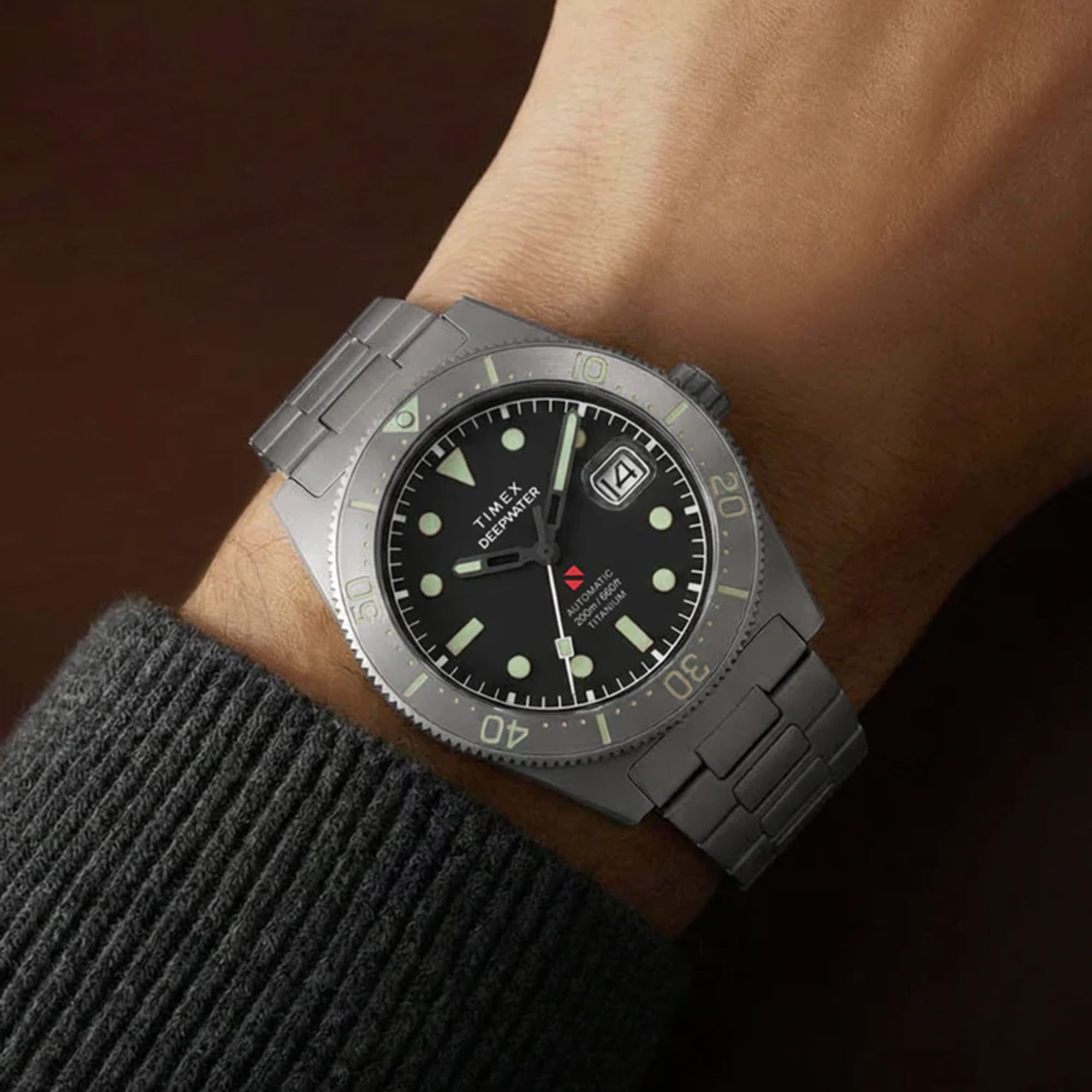 Timex Deepwater Reef 200 Titanium Automatic men’s watch with black dial, brushed titanium bracelet, and 41mm titanium case featuring a unidirectional dive bezel in a rugged professional dive watch design - on hand