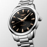 Silver Longines watch with black dial on a light gray background - 3