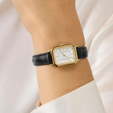 Timex Vivienne Trend women’s watch with white dial, black leather strap, and 21mm gold-tone rectangular case in a classic vintage-inspired dress watch design - on wrist