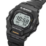 Casio G-Shock G-Squad GBD200-1A1 watch front view, featuring an all-black square resin case with positive mode MIP LCD display, orange accent on the lower button, honeycomb-patterned lens, and G-Shock branding, showing the digital time.