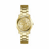 The Guess GW0861L2 is shown face-on, highlighting its 36mm gold-tone case and oversized Quattro 'G' logo dial. Croco-pattern texturing adds depth to the background of the design.
