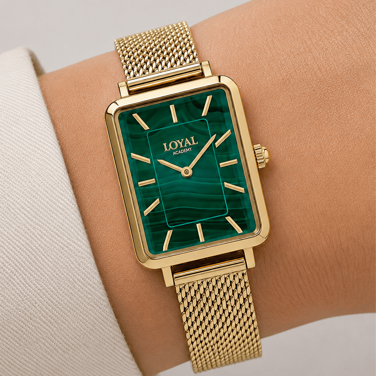 Close-up on-wrist detail of the Loyal Academy Gold PVD Women's Watch, reference 05A77FB01, highlighting the natural variation and texture of the genuine malachite dial. The mesh bracelet and mineral glass lens are visible against the wrist for scale.