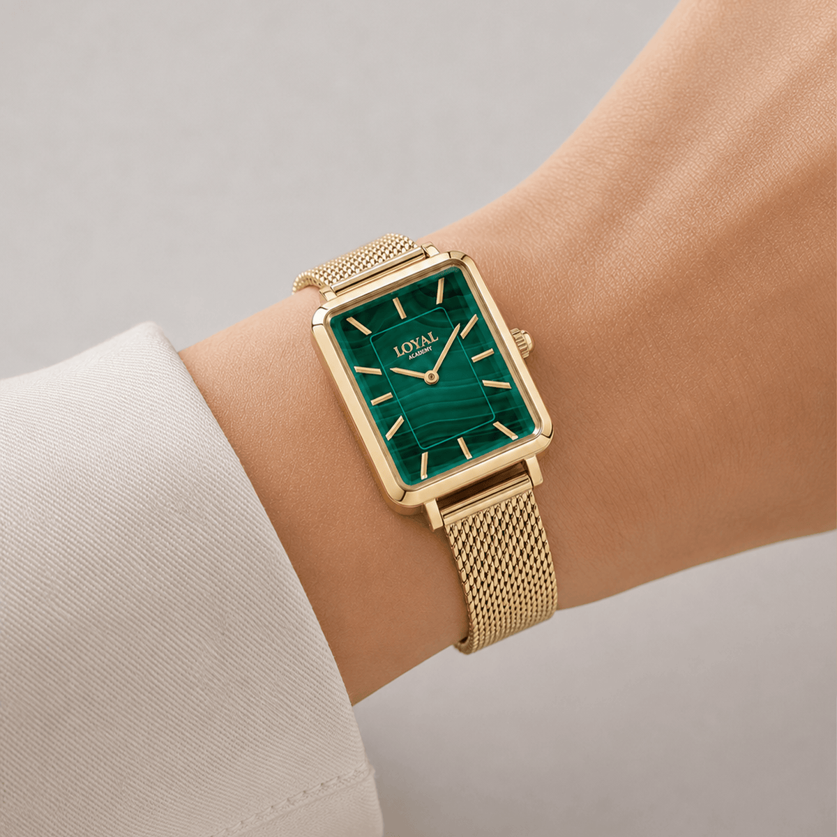 The Loyal Academy Gold PVD Women's Watch worn on the wrist, showing the true scale of the 24.50mm case and malachite stone dial. The Gold PVD finish and mesh bracelet give this quartz watch a polished, versatile look for daily wear.
