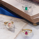 Three diamond rings with gemstones on an open book