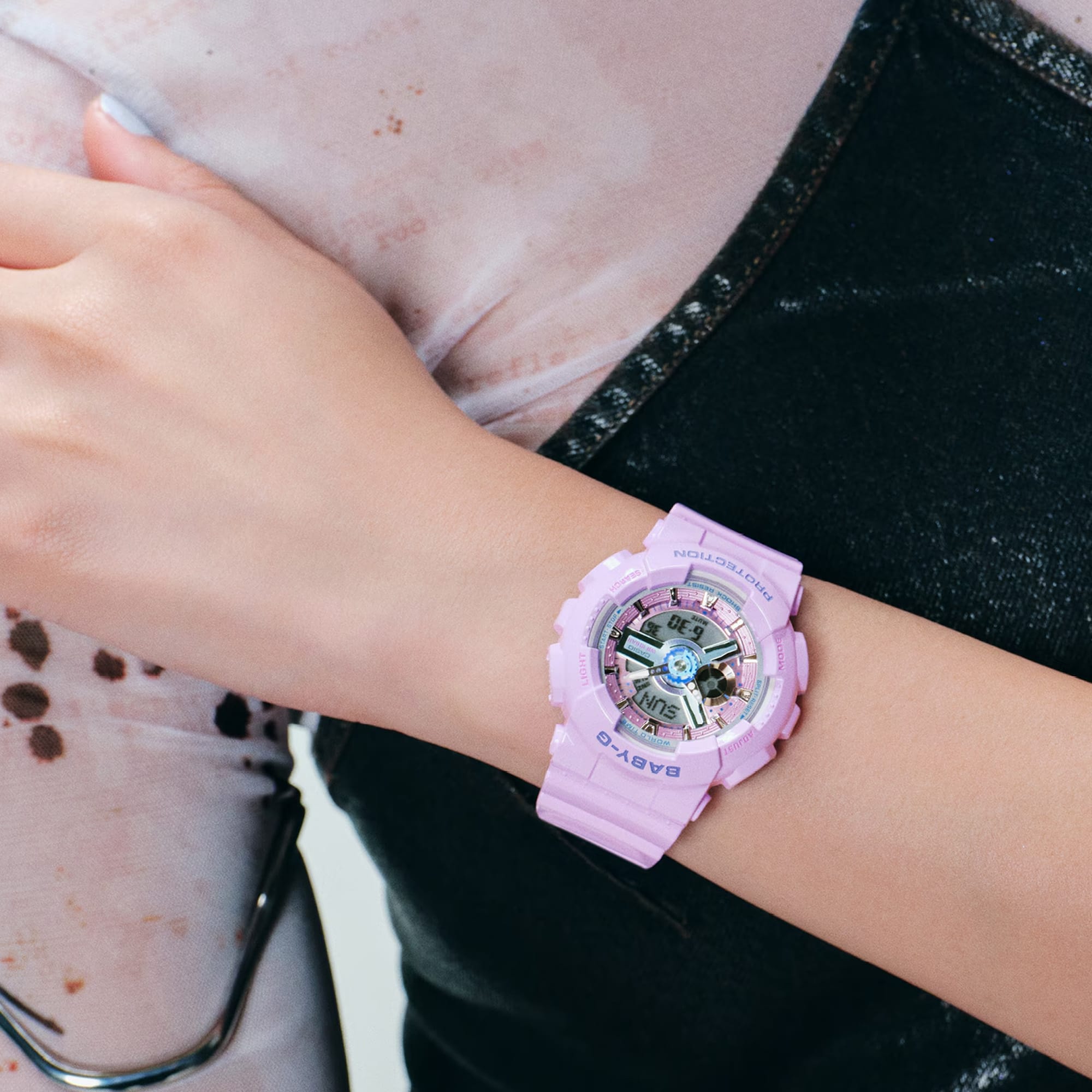 Casio Baby-G BA110MC-6A analogue digital watch worn on wrist, showing light pink resin band and case with layered dial detail and metallic index markers.