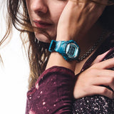 The Casio BABY-G BG169CM-2D Digital Women's Watch worn on the wrist to show scale and fit. The teal camo bezel and band suit an active, everyday lifestyle.