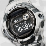 Close-up of the dial on the Casio BABY-G BG169CMB-8D Digital Women's Watch, showing the negative LCD display and metallic ion-plated bezel detail. The camouflage band pattern is shown up close.