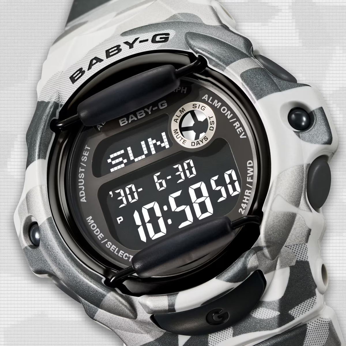 Close-up of the dial on the Casio BABY-G BG169CMB-8D Digital Women's Watch, showing the negative LCD display and metallic ion-plated bezel detail. The camouflage band pattern is shown up close.