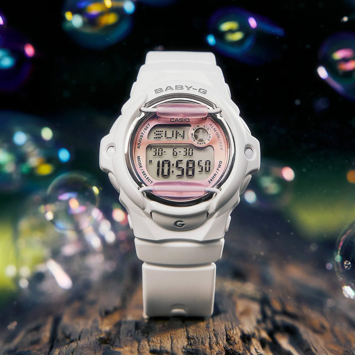 Lifestyle shot of the Casio Baby-G Digital Women's Watch BG169GD-7D, 42mm case, styled in an everyday casual setting. The matte off-white finish and compact round silhouette are shown in a natural, real-world context.