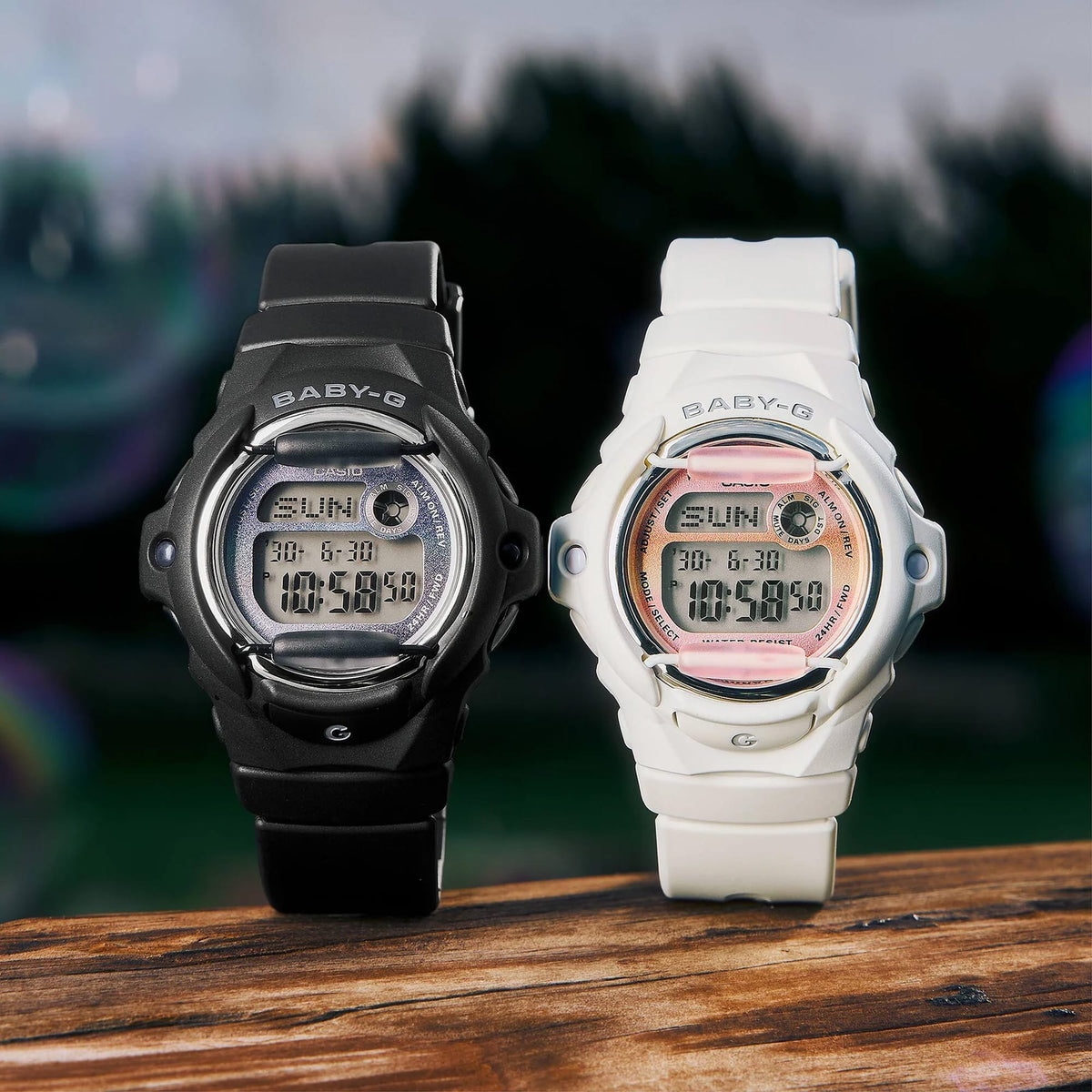 The Casio Baby-G Digital Women's Watch BG169GD-7D, 42mm case, worn alongside the Casio Baby-G Digital Women's Watch BG169GD-1D on a second wrist. The matte off-white and black colourways are shown side by side for comparison.