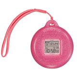 The Casio Baby-G BGD10KG-4D centre case removed from the bezel and inserted into the included customisable silicone holder with acrylic panels — shown as a bag charm or waist accessory with the rotating pixel-art animations visible on the LCD display.