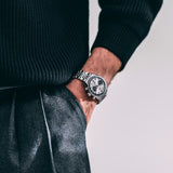 TAG Heuer Carrera Chronograph CBS2216.BA0048 shown worn on the wrist, illustrating the case proportions and steel bracelet fit. The silver dial stands out against the sleeve in frame.