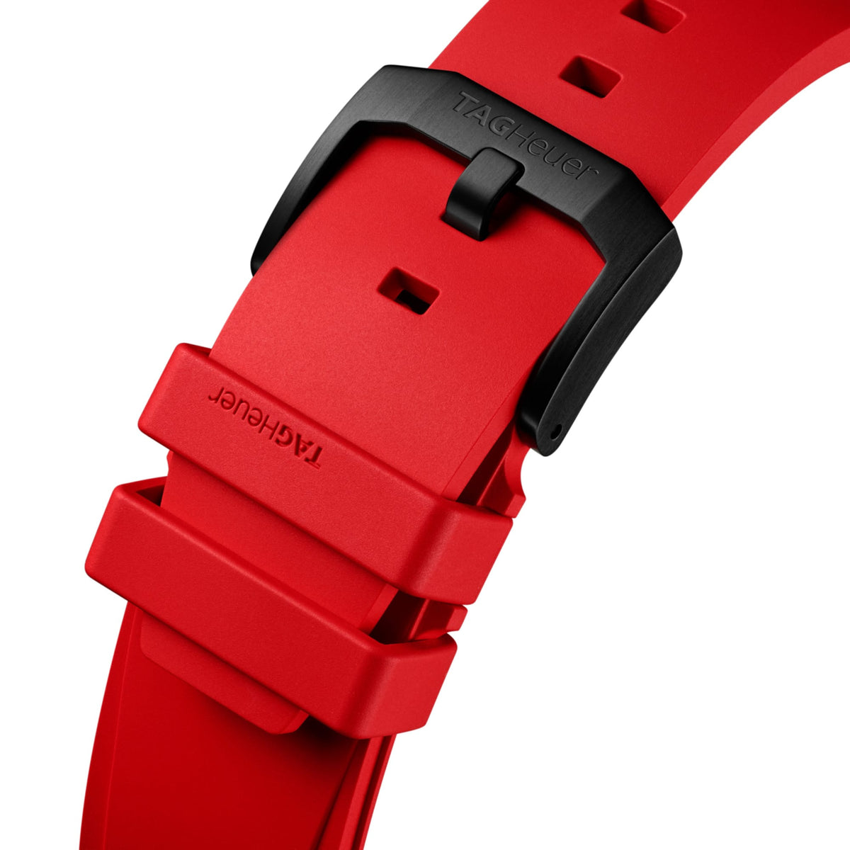 TAG Heuer Formula 1 Chronograph CBZ2085.FT8093 photographed in close-up focusing on the red rubber strap and its black DLC-coated buckle. The strap's texture and stitching are visible in detail.